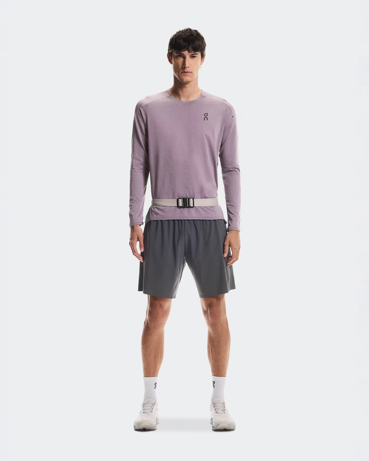Man wearing a light purple long-sleeve shirt and gray shorts on a white background - On Speed Belt (Unisex) - Fog