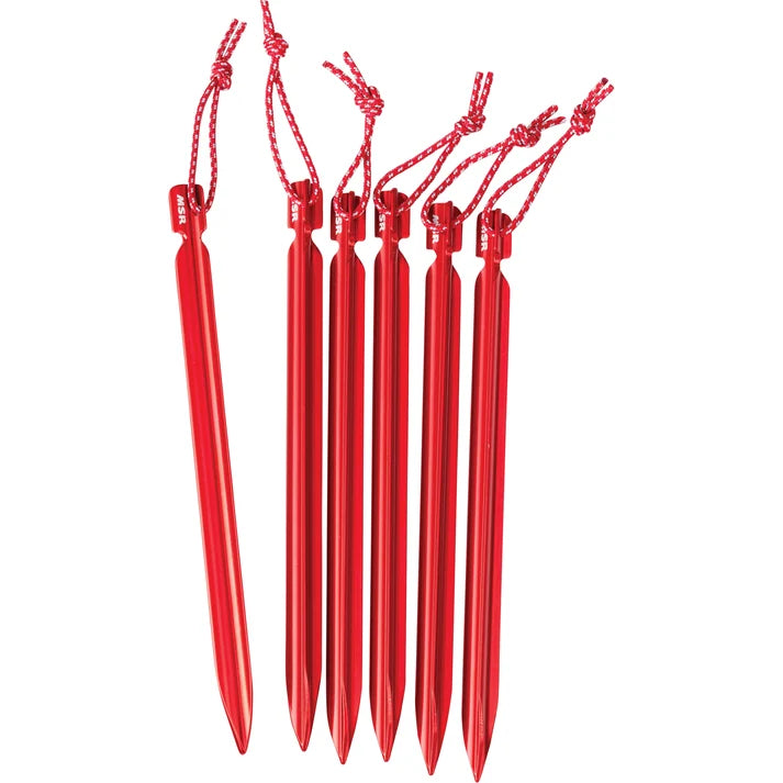 Six red metal tent stakes with hanging red cords, arranged upright on a plain white background. - MSR Mini Groundhog Tent Stakes