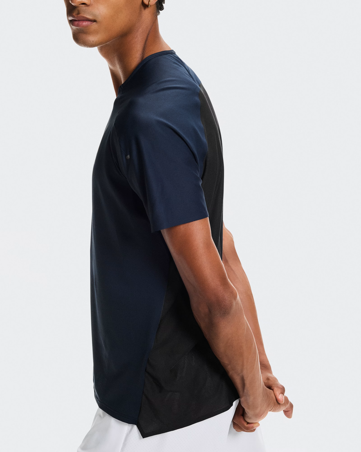 Person wearing a navy blue t-shirt with a black panel on a white - On Performance-T (Men's) - Navy/Blackbackground