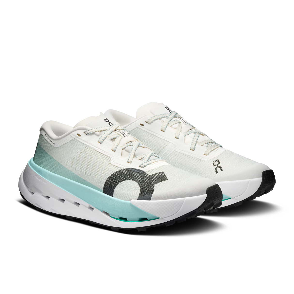 A pair of white running shoes with a light blue and gray accent design, featuring the 'ooc' logo on the side and tongue, set against a plain white background. - On Cloudultra Pro Shoes (Women's) - Ivory/Celeste