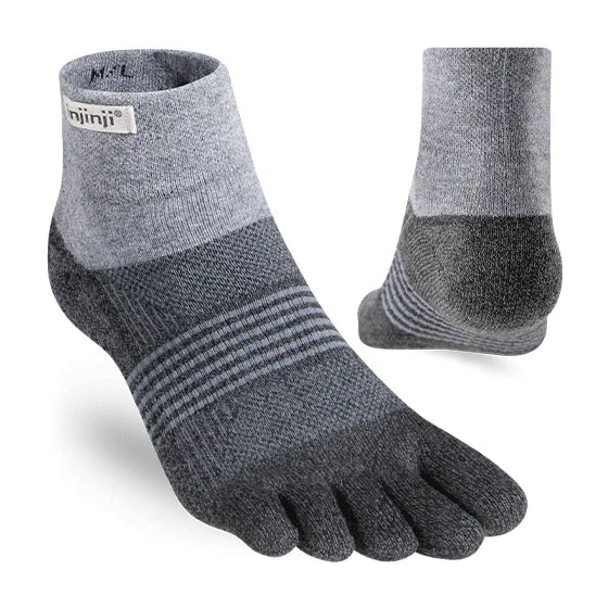 Gray five-toe socks with a brand label on a white background - Injinji Trail 2.0 Midweight Mini-Crew Toesocks (Women's) - Granite