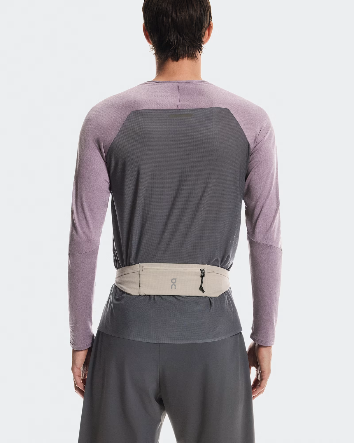 Person wearing a gray and purple long-sleeve shirt with a belt on a white background - On Speed Belt (Unisex) - Fog