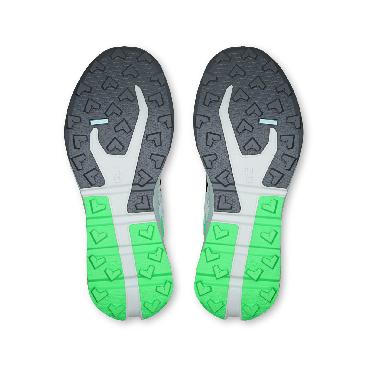 The soles of a pair of running shoes, viewed from above. The outsole features a dark gray and white patterned upper section and a bright green and white patterned heel section. - On Cloudvista 3 Shoes (Women's) - Flurry/Verdite