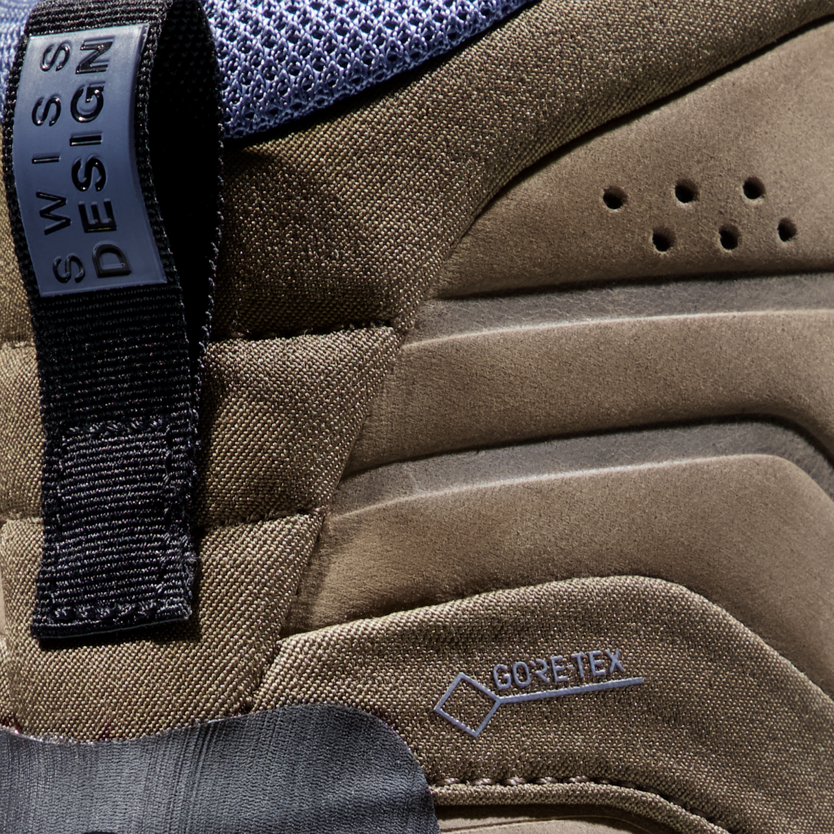 Close-up detail of a brown and gray outdoor boot showing the Swiss Design tab and a Gore-Tex logo on the side. - Mammut Nova Tour II High GORE-TEX Boots (Women's) - Oak/Bark
