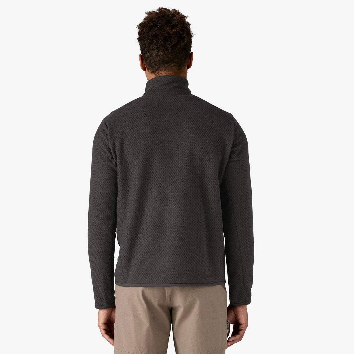 Person wearing a dark gray fleece jacket on a white background - Patagonia R1 Air Fleece Zip-Neck (Men's) - Black