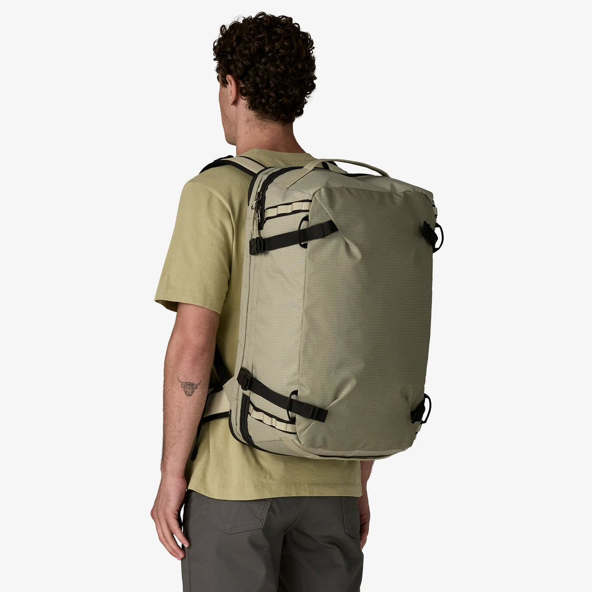 Person wearing a beige backpack on a white background - Patagonia Black Hole MLC Pack 45L - Weathered Stone