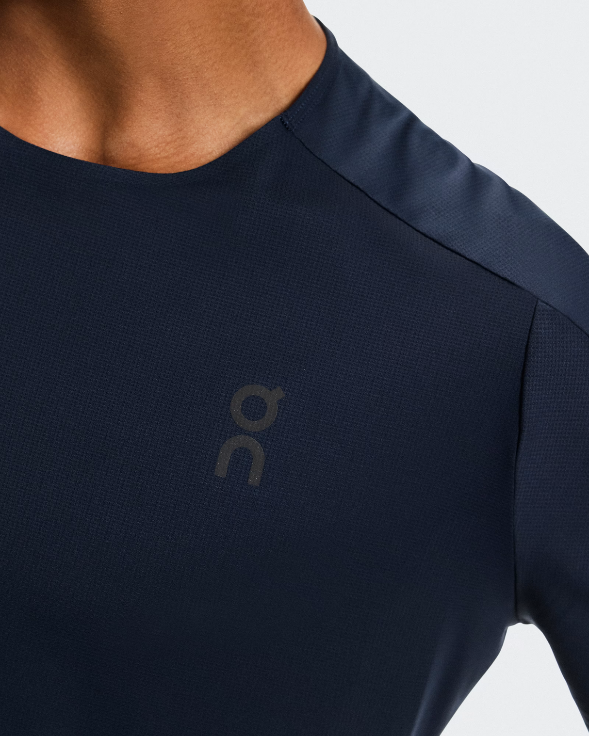 Navy blue athletic shirt with a logo on a light gray background - On Performance-T (Men's) - Navy/Black