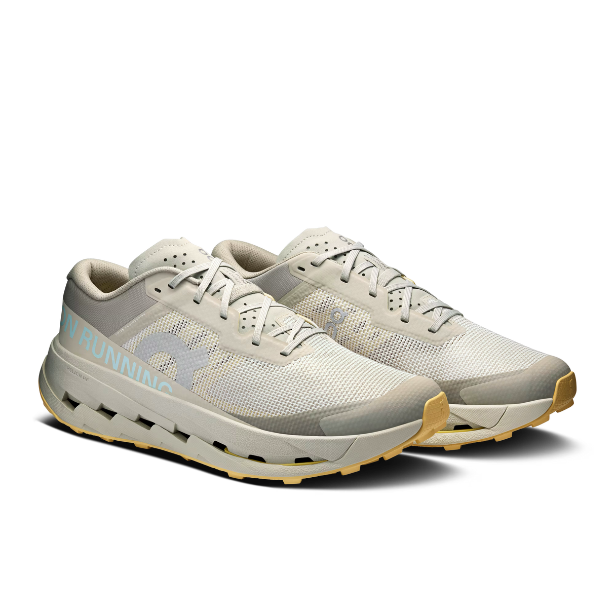 A pair of light gray and off-white running shoes with a light blue 'RUNNING' text detail on the side and a tan outsole, shown against a plain white background. - On Cloudultra 3 Shoes (Men's) - Brume/Winter