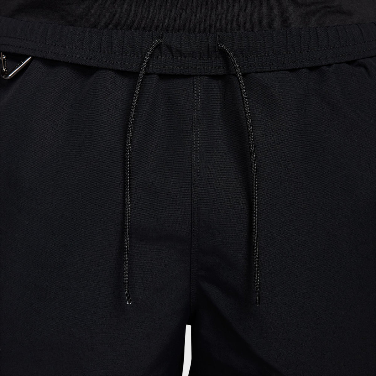 Close-up of black drawstring shorts showing the elastic waistband and drawstrings. - Nike ACG Reservoir Goat Shorts (Men's) - Black/Anthracite/Summit White