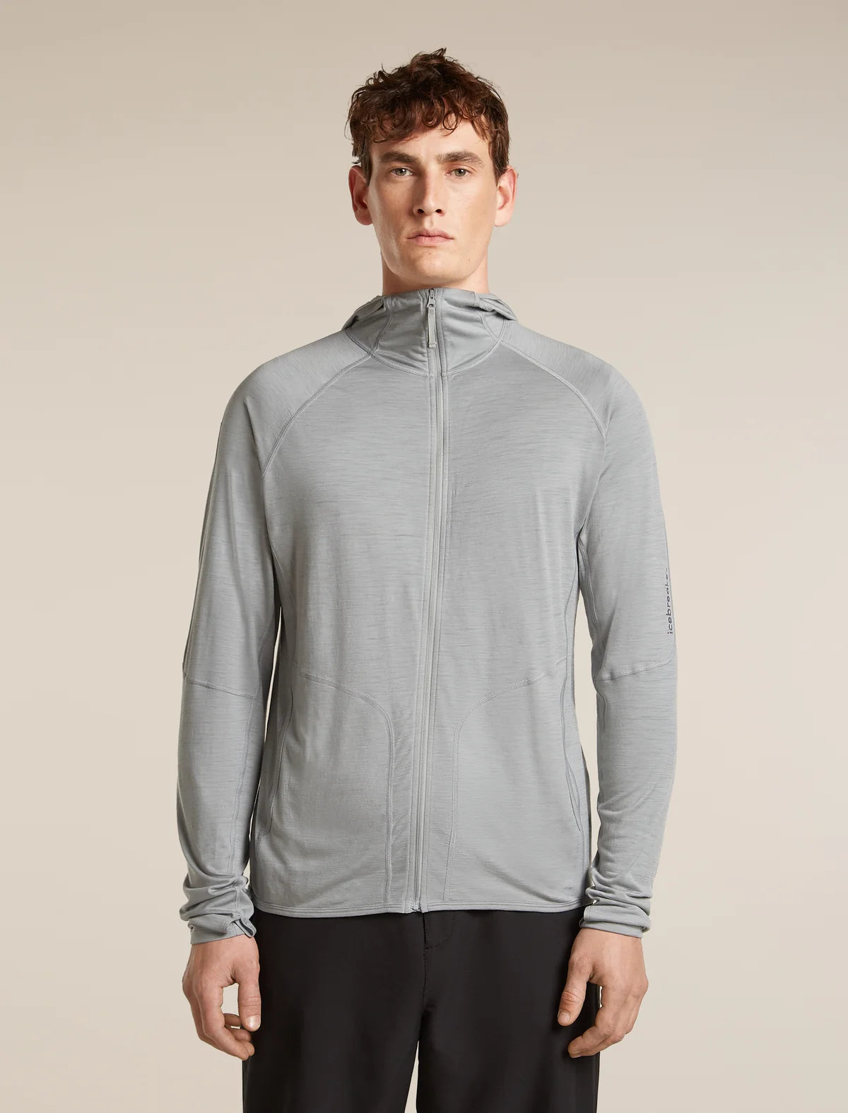 Man wearing a gray jacket on a beige background - Icebreaker 150 MerinoFine Ace Long Sleeve Zip Hoodie (Men's) - Proto Grey
