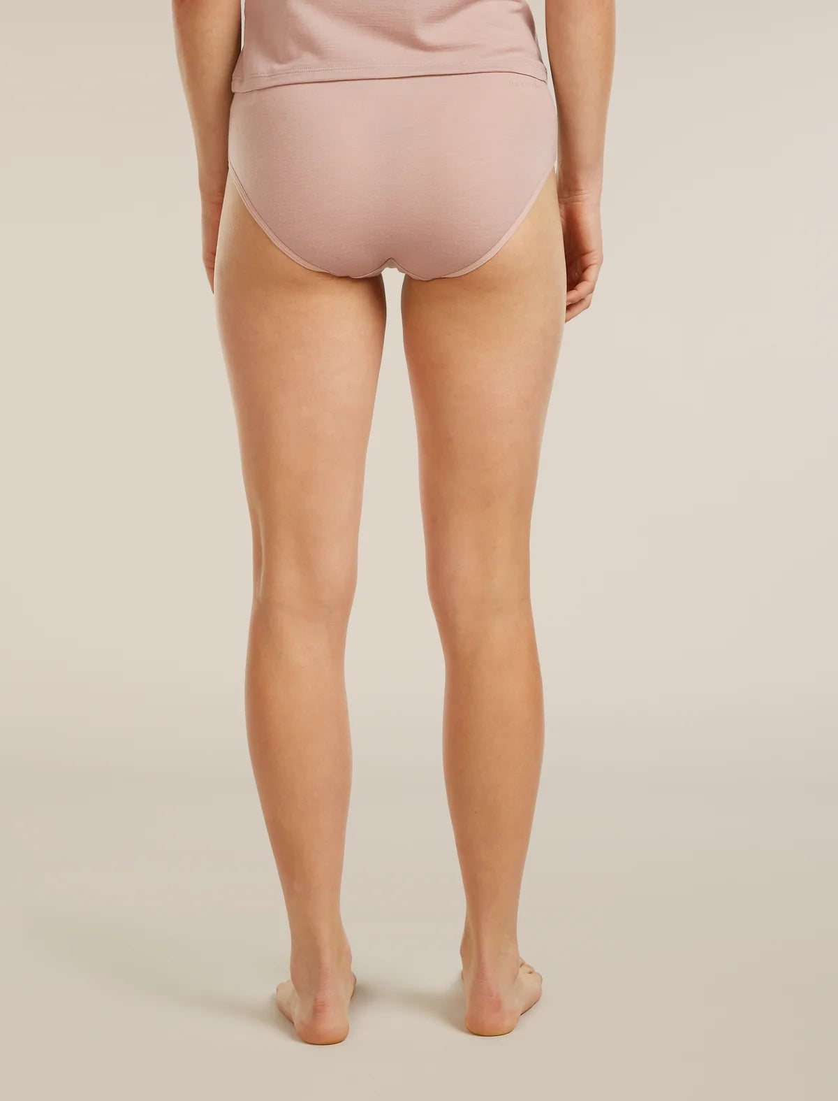 Person wearing light pink underwear on a beige background - Icebreaker Merino 150 Siren Hipkini (Women's) - Pink Quartz