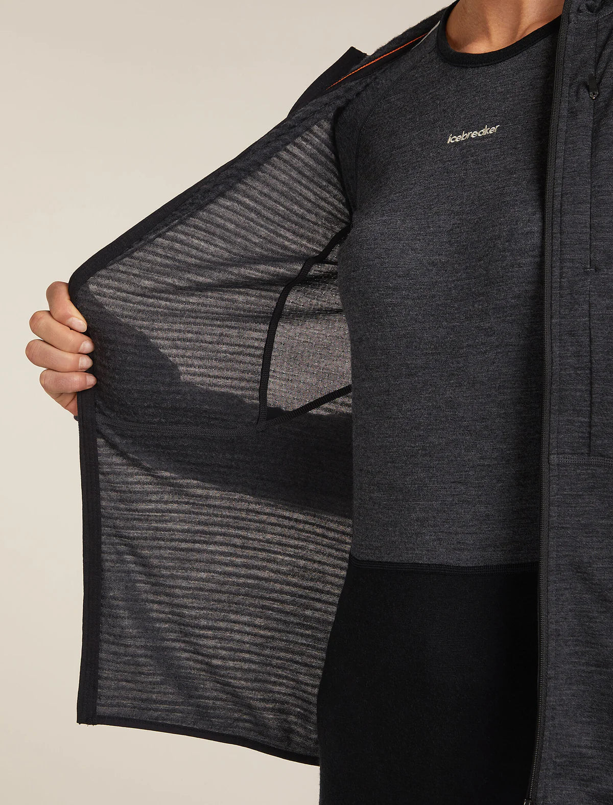 Person wearing a dark gray jacket with a visible brand logo on a neutral background - Icebreaker Merino Blend 200 Realfleece Descender Long Sleeve Zip Hoodie (Women's) - Jet Heather/Black