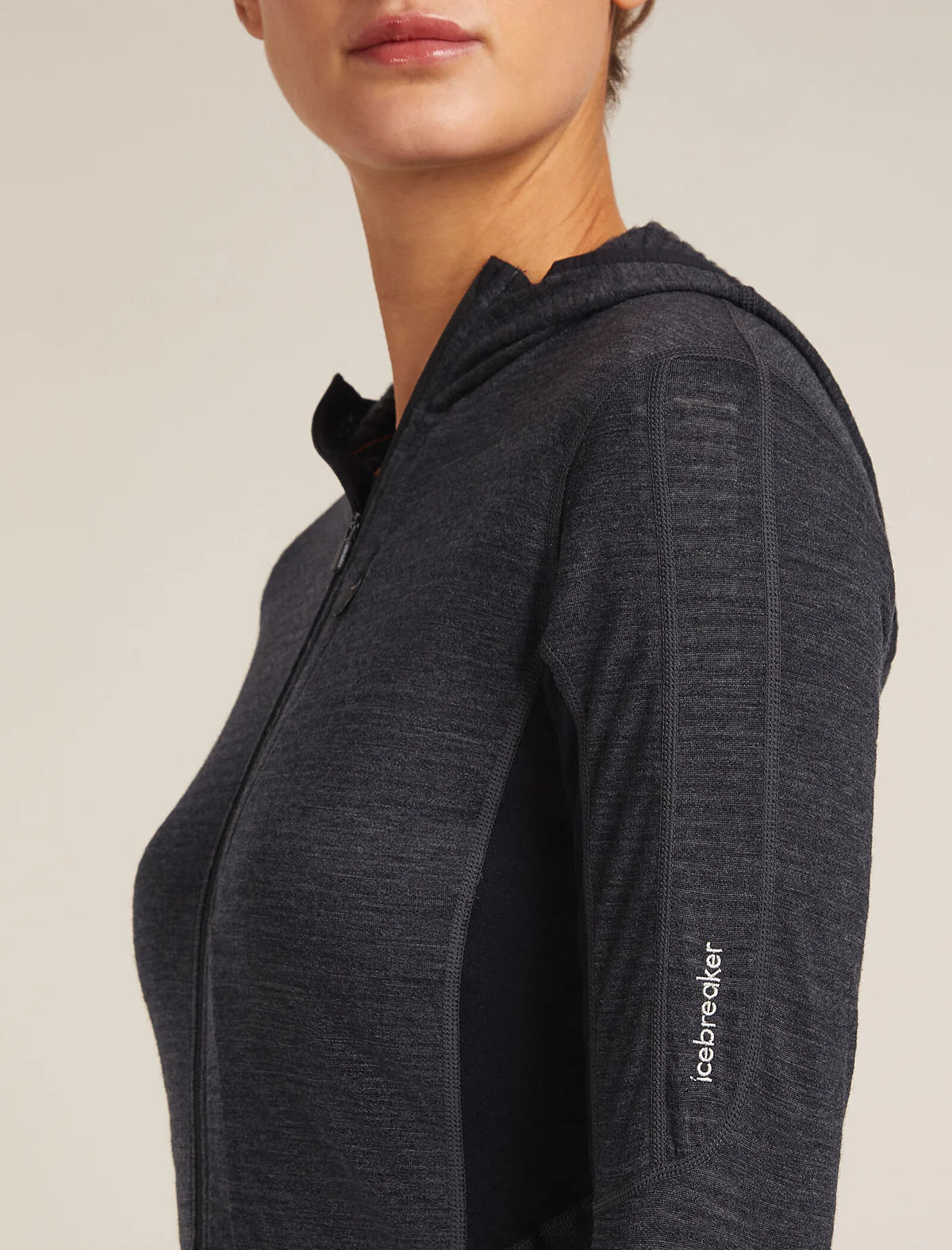 Dark gray zip-up hoodie with a visible brand logo on a beige background - Icebreaker Merino Blend 200 Realfleece Descender Long Sleeve Zip Hoodie (Women's) - Jet Heather/Black