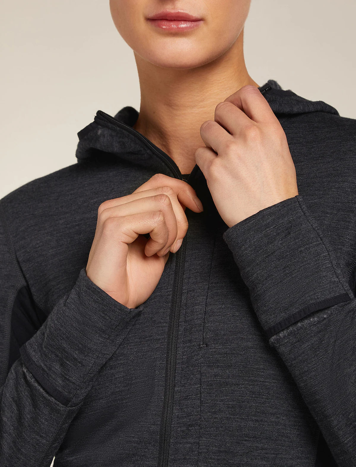 Person wearing a dark gray hoodie with a neutral background - Icebreaker Merino Blend 200 Realfleece Descender Long Sleeve Zip Hoodie (Women's) - Jet Heather/Black