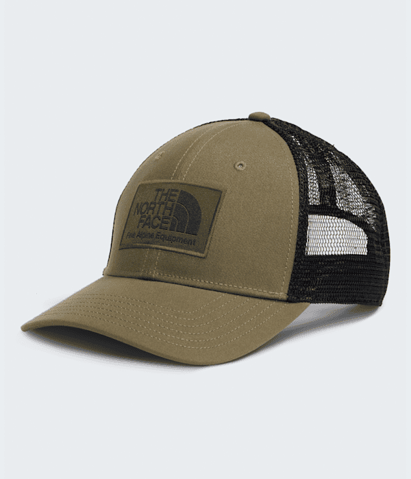 A trucker-style baseball cap by The North Face, featuring an olive green front panel and visor with a black mesh back, shown on a light gray background. - The North Face Mudder Trucker - Caraway Seed