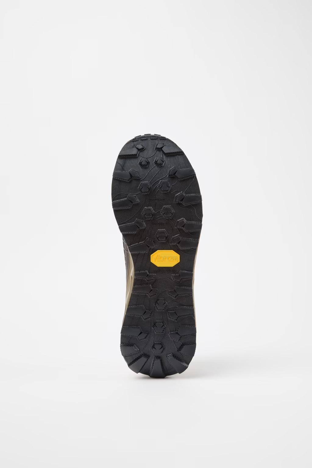 Black sole of a shoe with a yellow label on a white background - NNormal Tomir 2.0 GORE-TEX Shoes (Unisex) - Brown/Black