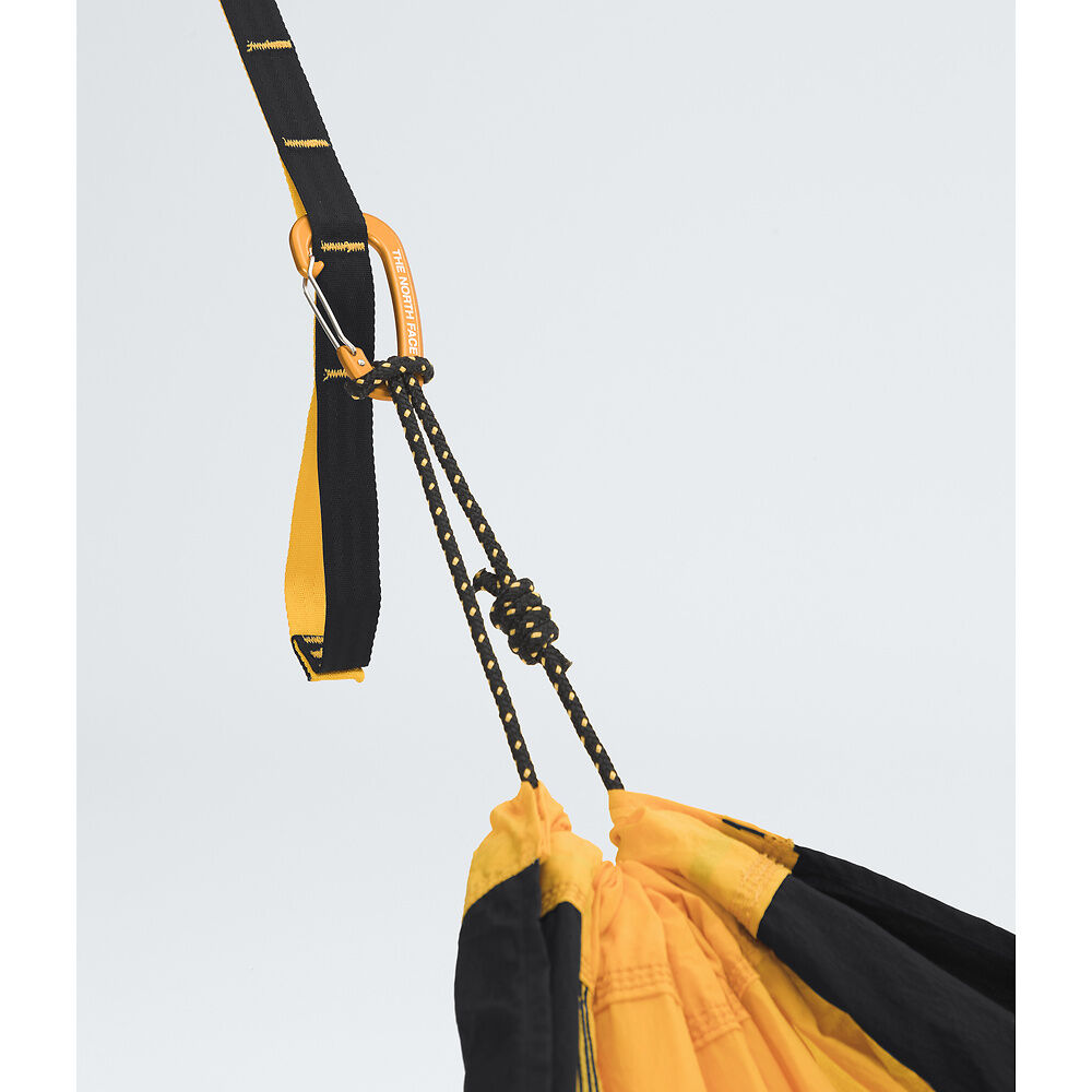 Close-up of a yellow and black hammock with straps against a light gray background - The North Face Wawona Camp Hammock - Summit Gold/TNF Black