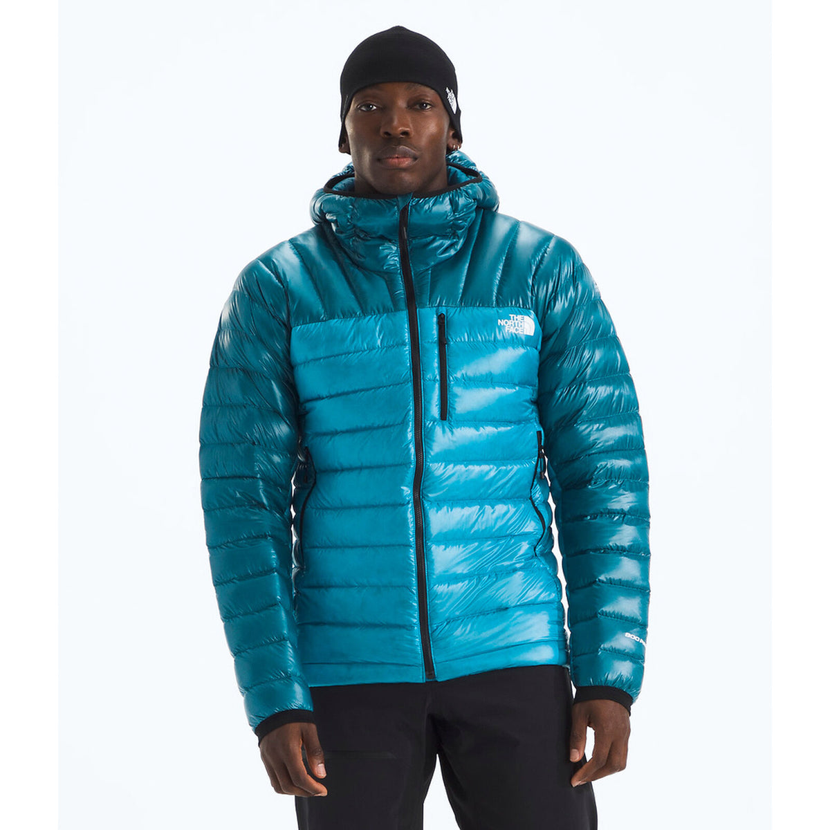 Person wearing a blue puffer jacket with a brand logo on a white background - The North Face Summit Series Breithorn Hoodie (Men's) - Meridian Blue/Dusk Blue