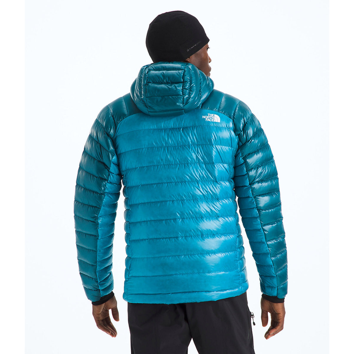 Person wearing a blue puffer jacket with a brand logo on a white background - The North Face Summit Series Breithorn Hoodie (Men's) - Meridian Blue/Dusk Blue