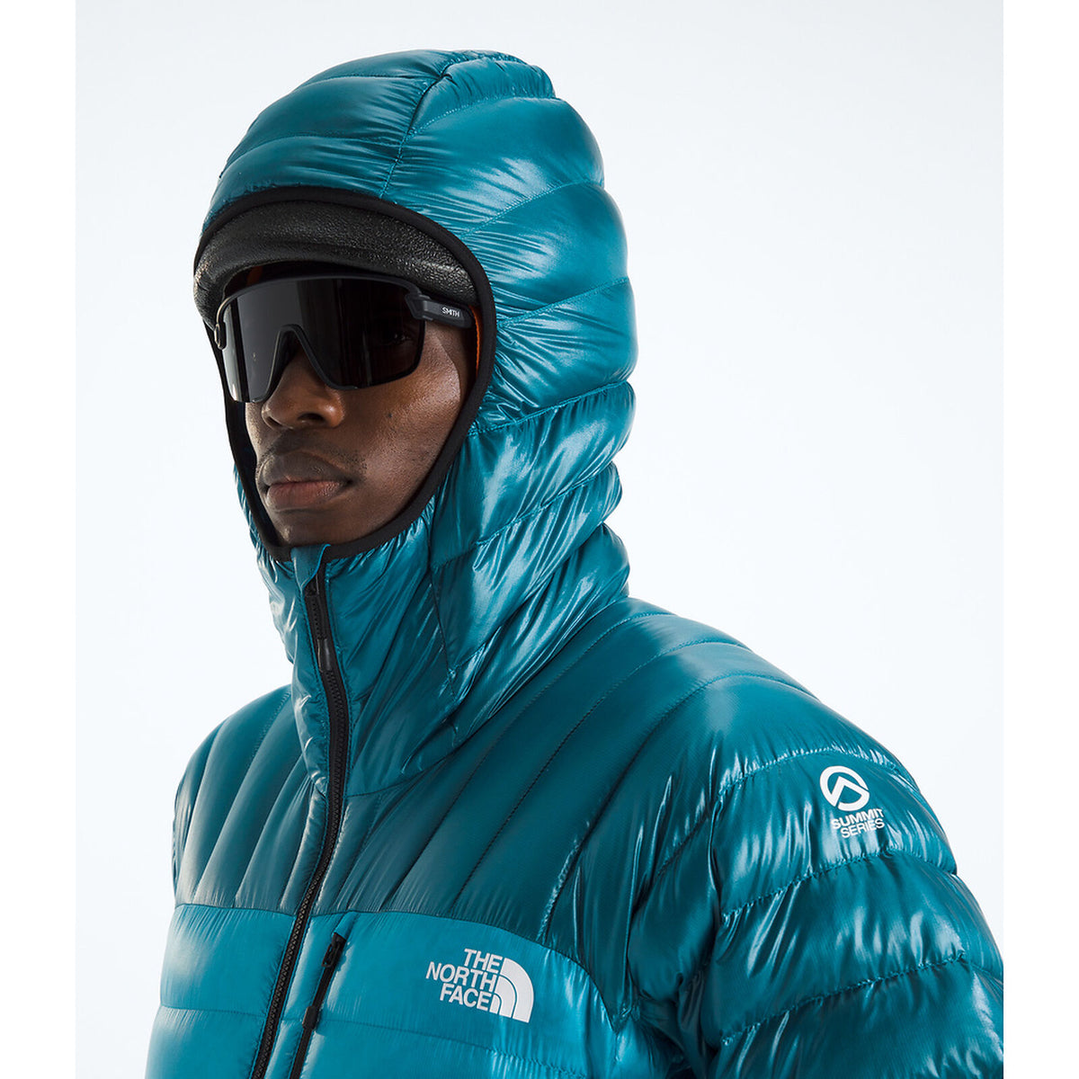 Person wearing a blue North Face jacket with a hood and goggles on a white background - The North Face Summit Series Breithorn Hoodie (Men's) - Meridian Blue/Dusk Blue