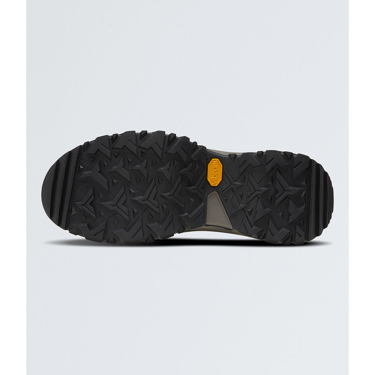 The bottom sole of a black Vibram hiking boot, showing a deep tread pattern and the signature yellow Vibram logo, set against a light gray background. - The North Face Hedgehog Mid GORE-TEX Boots (Women's) - TNF Black/Asphalt Grey