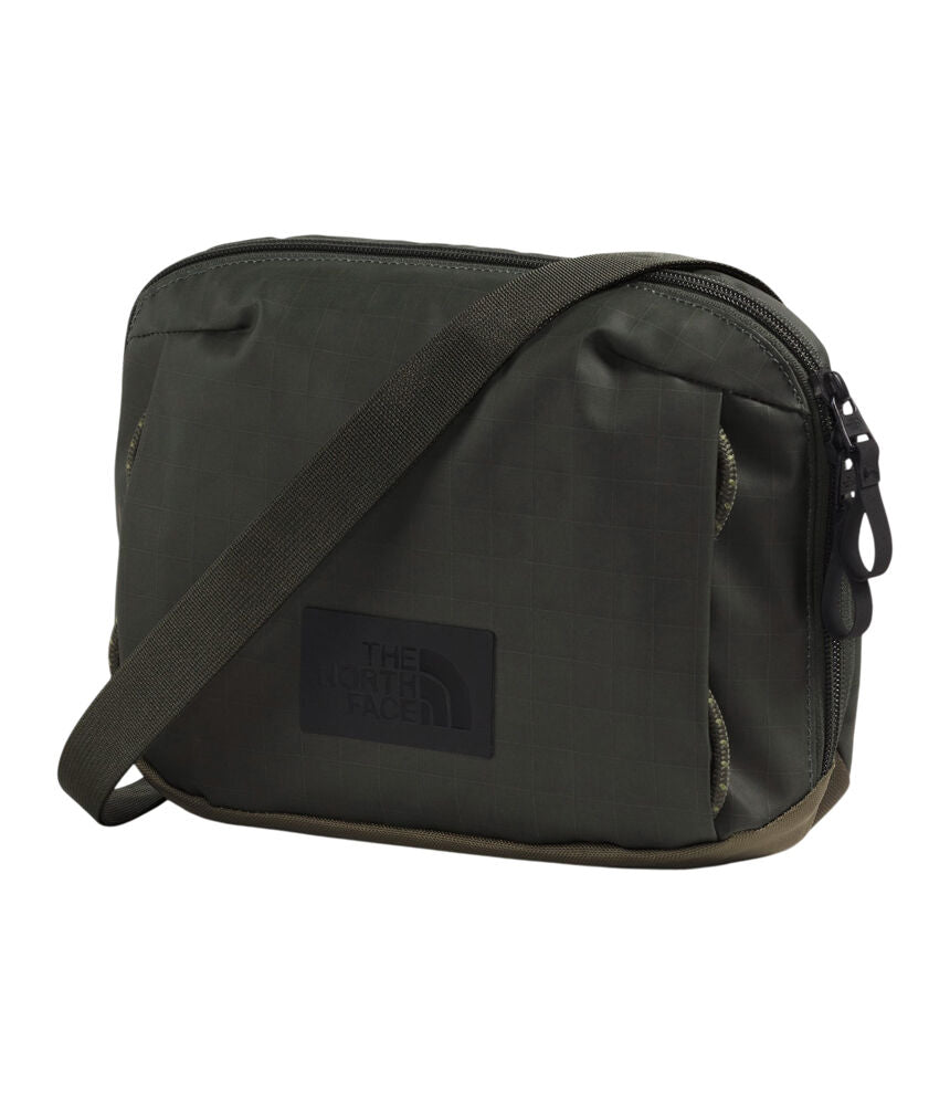 The North Face dark olive green nylon shoulder bag with a black brand patch on the front, set against a plain white background. - The North Face Base Camp Voyager Pro Crossbody Bag - New Taupe Green/TNF Black