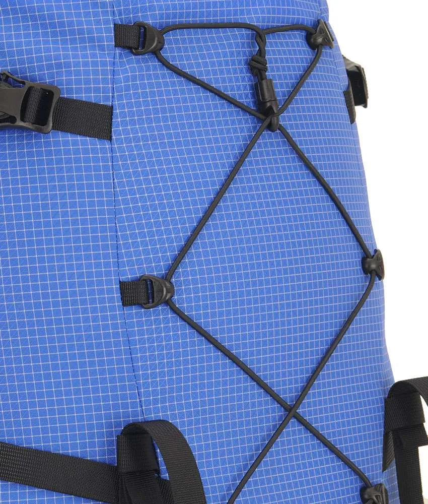Close-up of a blue grid-patterned backpack with black compression straps and plastic buckles, showing the side and front lacing details against a white background. - One Planet Extrovert 55 Pack - Blue
