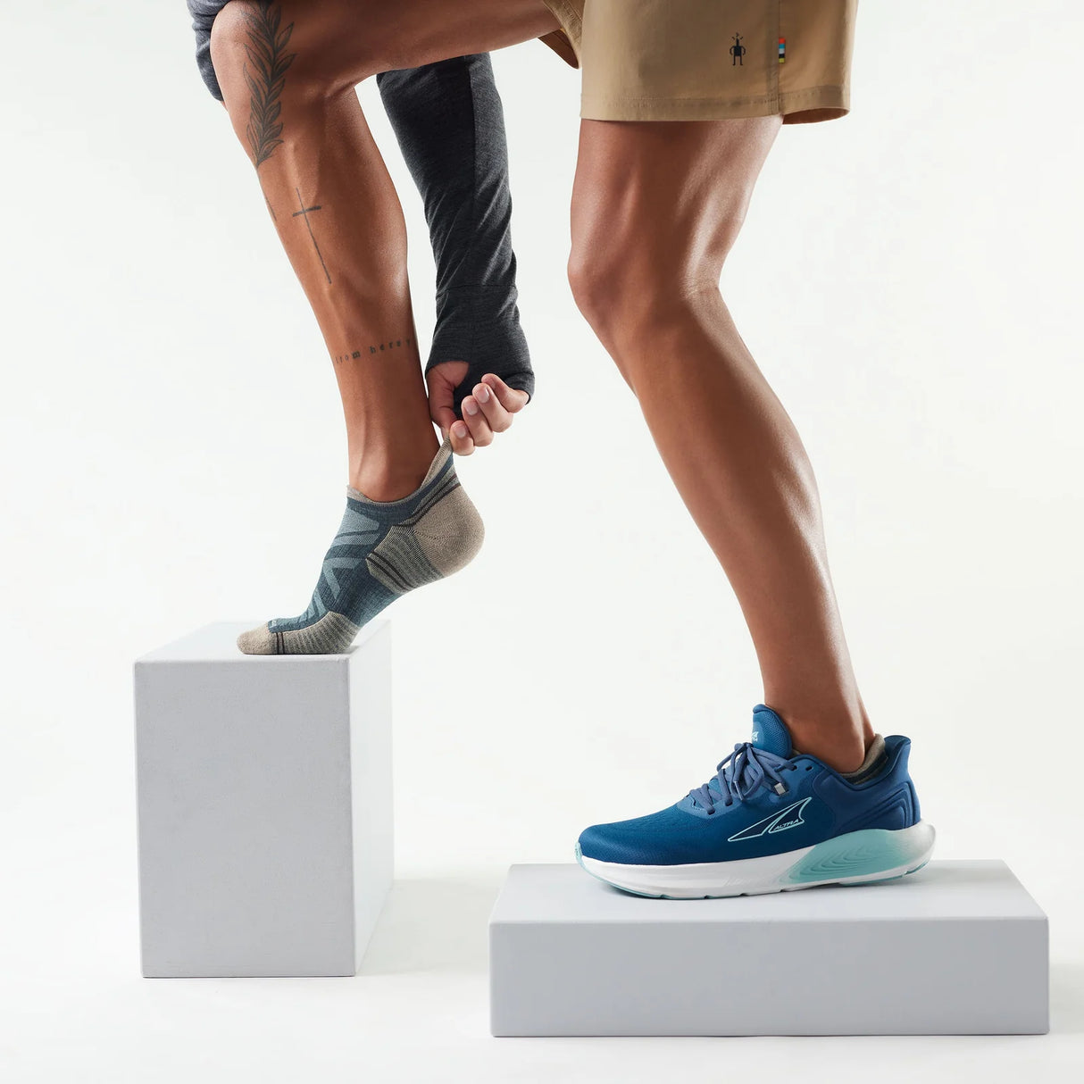 Person wearing blue running shoes on a white background - Smartwool Hike Targeted Cushion Low Ankle Socks (Unisex) - Twilight Blue