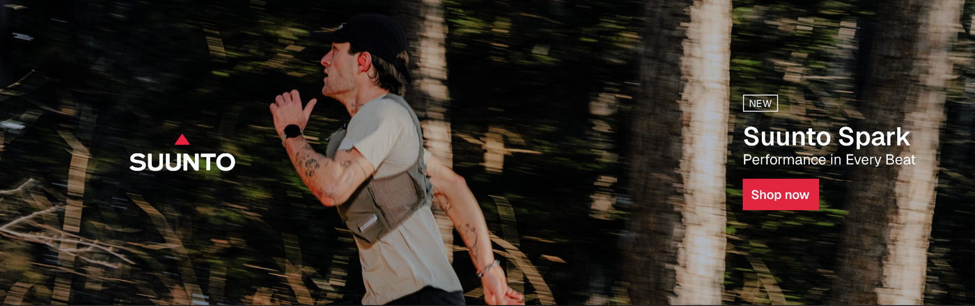 Person running wearing sunnto spark headphones with Suunto branding and product advertisement in the background