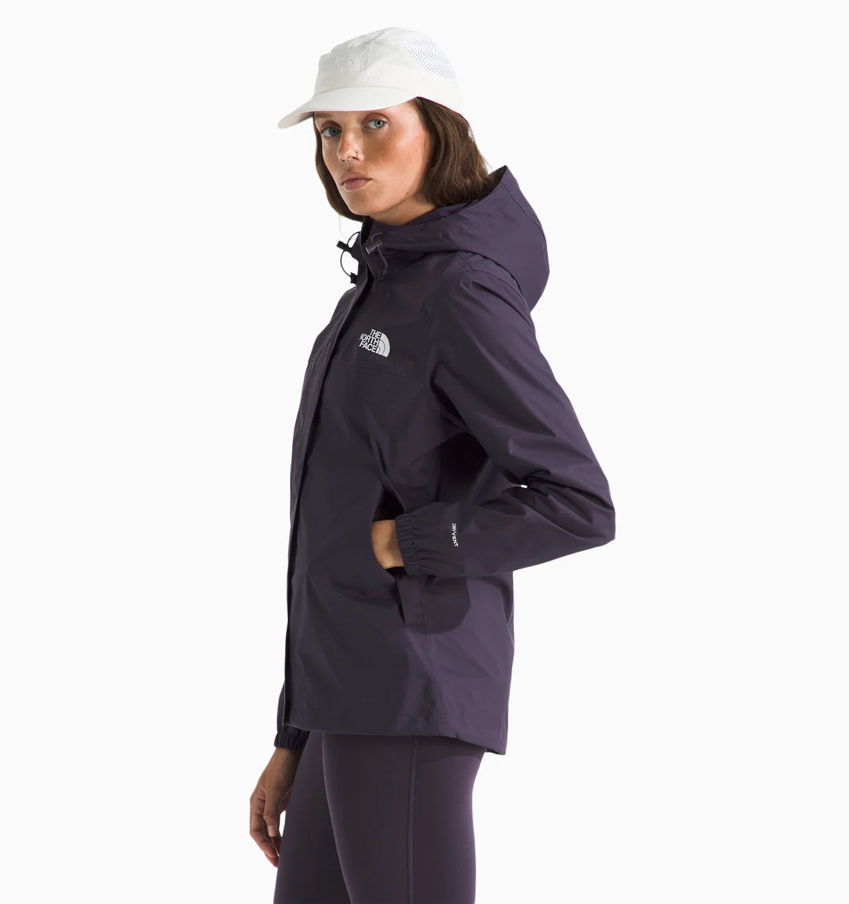 Woman wearing a the north face antora rain jacket in purple with the brand logo on the chest. with white background