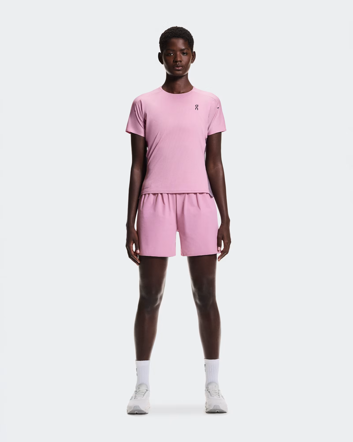 Person wearing a pink outfit with a white background - On Performance-T (Women's) - Dewberry/Sakura