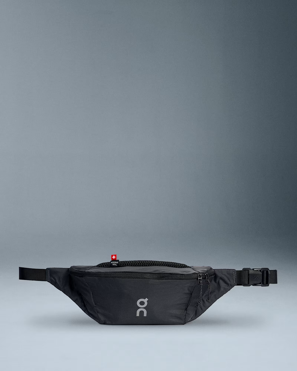 Black waist bag with a visible brand logo on a gray background - On Waist Pack 2L Lite - Magnet