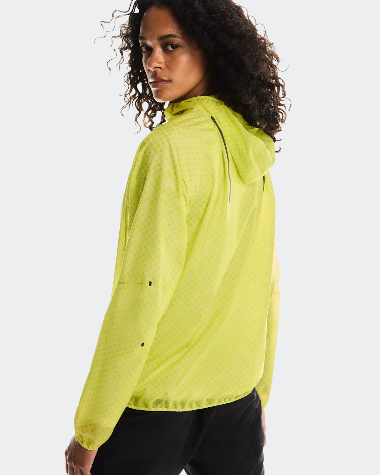 Woman wearing a bright yellow jacket on a white background - On Ultra Jacket (Women's) - Limelight/Lime