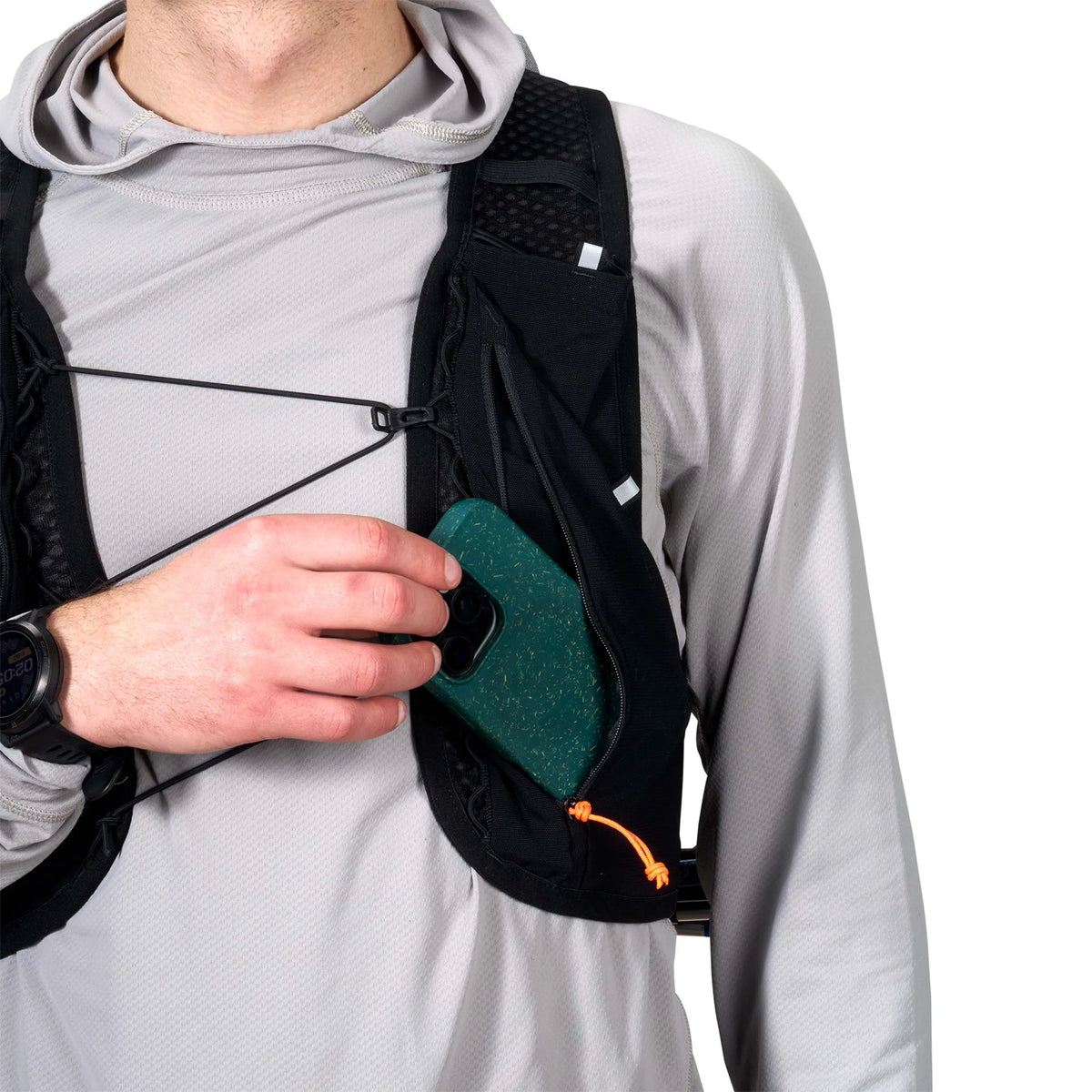 Person wearing a black backpack with a green pouch, holding a phone. - Hyperlite Mountain Gear Pemi 15 Backpack
