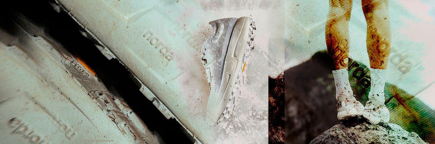 man running on a sand dune in black and white wearing salomon trail shoes