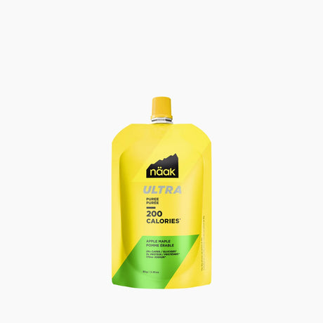A yellow and green Naak Ultra Power Pures 200 Calorie drink pouch in Apple Apple flavor, shown on a clean white background. - Näak Ultra Puree 200 - Apple & Maple Syrup