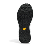 The black rubber outsole of a shoe, featuring a textured tread pattern and a small yellow Vibram logo near the heel, shown against a white background. - norda 001A Shoes (Women's) - Black