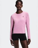 Person wearing a pink long-sleeve athletic shirt and black shorts on a white background - On Performance Long-T (Women's) - Dewberry/Sakura