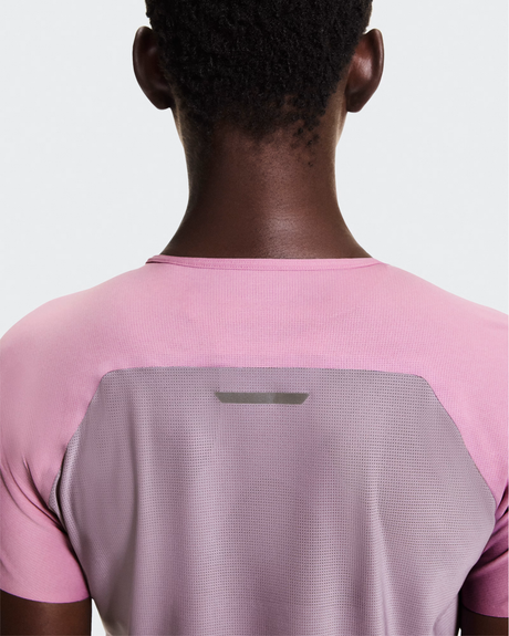 Person wearing a pink and gray athletic shirt on a white background - On Performance-T (Women's) - Dewberry/Sakura
