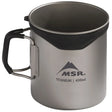An MSR titanium camping mug with a black handle and a black silicone liner inside the rim, shown on a white background. - MSR Titan Cup