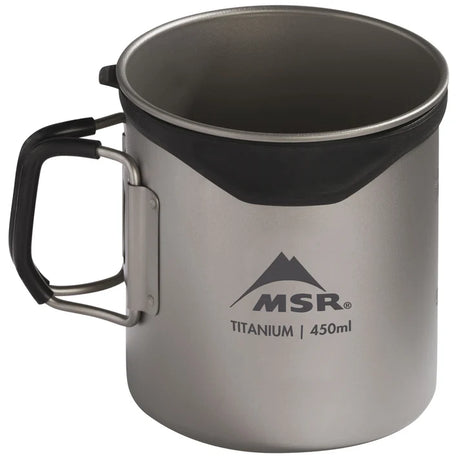 An MSR titanium camping mug with a black handle and a black silicone liner inside the rim, shown on a white background. - MSR Titan Cup