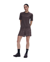 A woman modeling a matching athletic set consisting of a short-sleeve crewneck shirt and patterned shorts in a dark brown color, paired with black socks and trail running shoes, against a plain white background. - On Trail-T Solar (Women's) - Mulberry