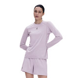 A woman modeling a light lavender athletic long-sleeve top and matching shorts against a plain white background. - On Trail Long-T Solar (Women's) - Foxglove