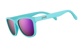 Goodr ELECTRIC DINOTOPIA CARNIVAL turquoise sunglasses with pink lenses on a white background