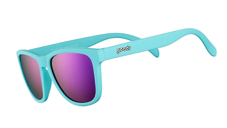 Goodr ELECTRIC DINOTOPIA CARNIVAL turquoise sunglasses with pink lenses on a white background