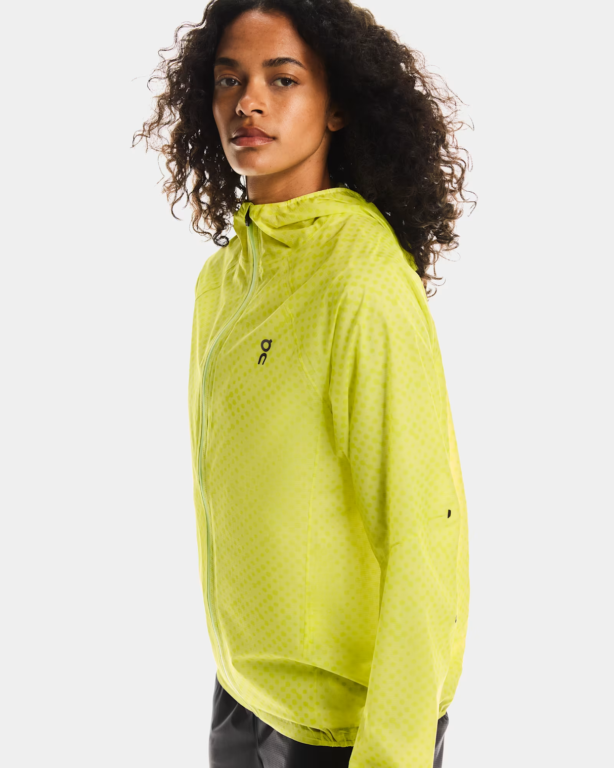 Person wearing a bright green athletic jacket on a white background - On Ultra Jacket (Women's) - Limelight/Lime