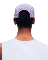 Rear view of a person wearing a light lavender mesh-back baseball cap with a black adjustable strap, paired with a white sleeveless shirt against a plain white background. - On Lightweight Cap - Mallow