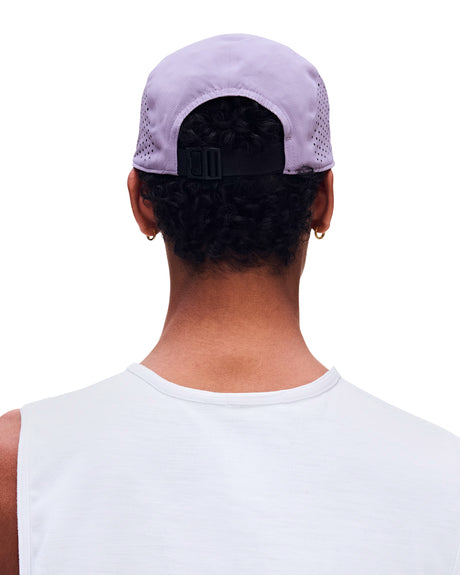 Rear view of a person wearing a light lavender mesh-back baseball cap with a black adjustable strap, paired with a white sleeveless shirt against a plain white background. - On Lightweight Cap - Mallow