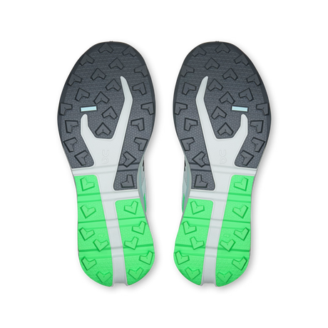 The soles of a pair of running shoes, viewed from above. The outsole features a dark gray and white patterned upper section and a bright green and white patterned heel section. - On Cloudvista 3 Shoes (Women's) - Flurry/Verdite