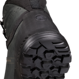 Close-up detail shot of the outsole and heel area of a black snowboard boot, showing the tread pattern and a circular logo embossed on the heel counter. - Mammut Mercury Tour II High GORE-TEX (Men's) - Black/Black